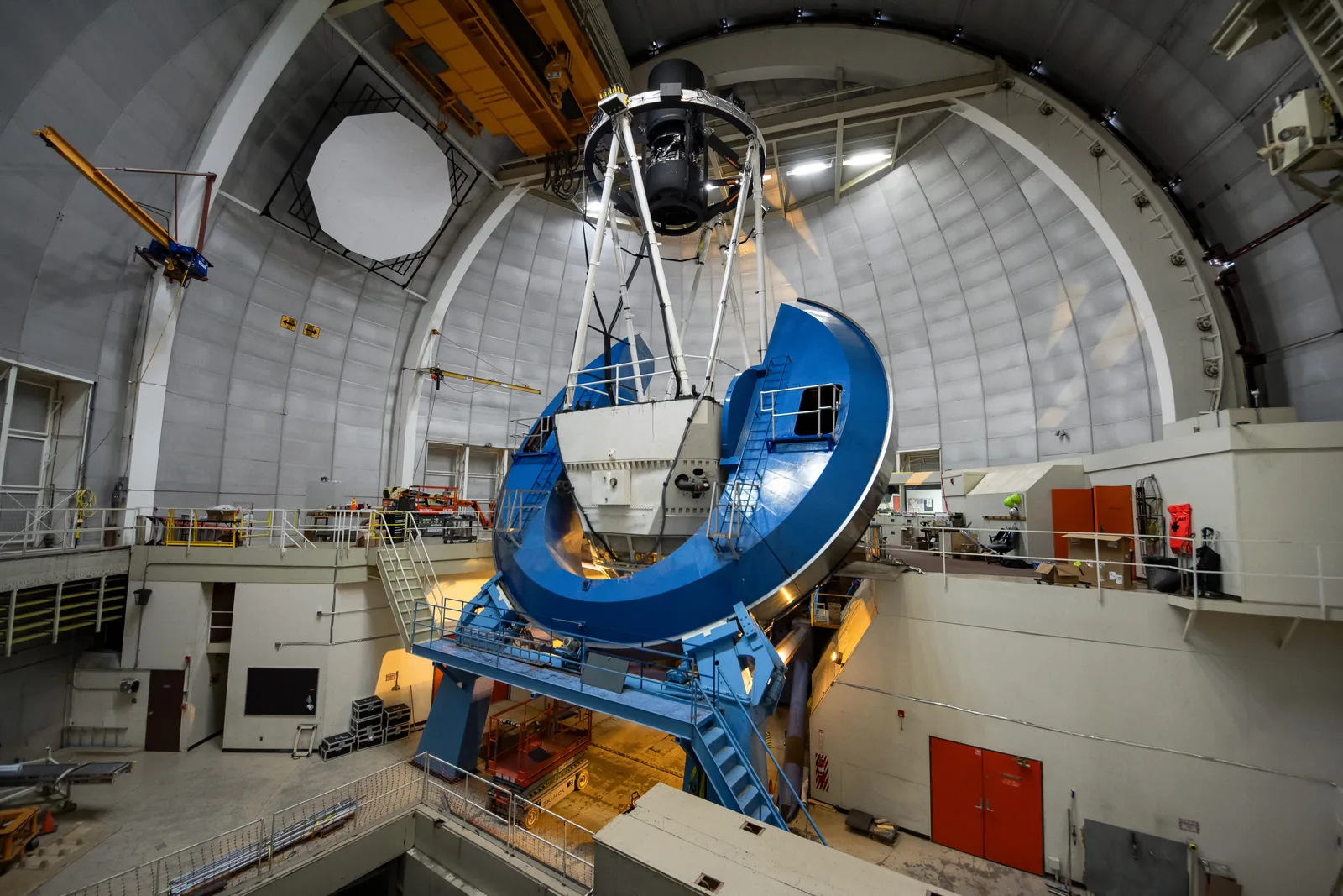 The DESI instrument installed on the Nicholas U. Mayall 4-meter Telescope at Kitt Peak, with the telescope structure and instrument hardware visible inside the dome.