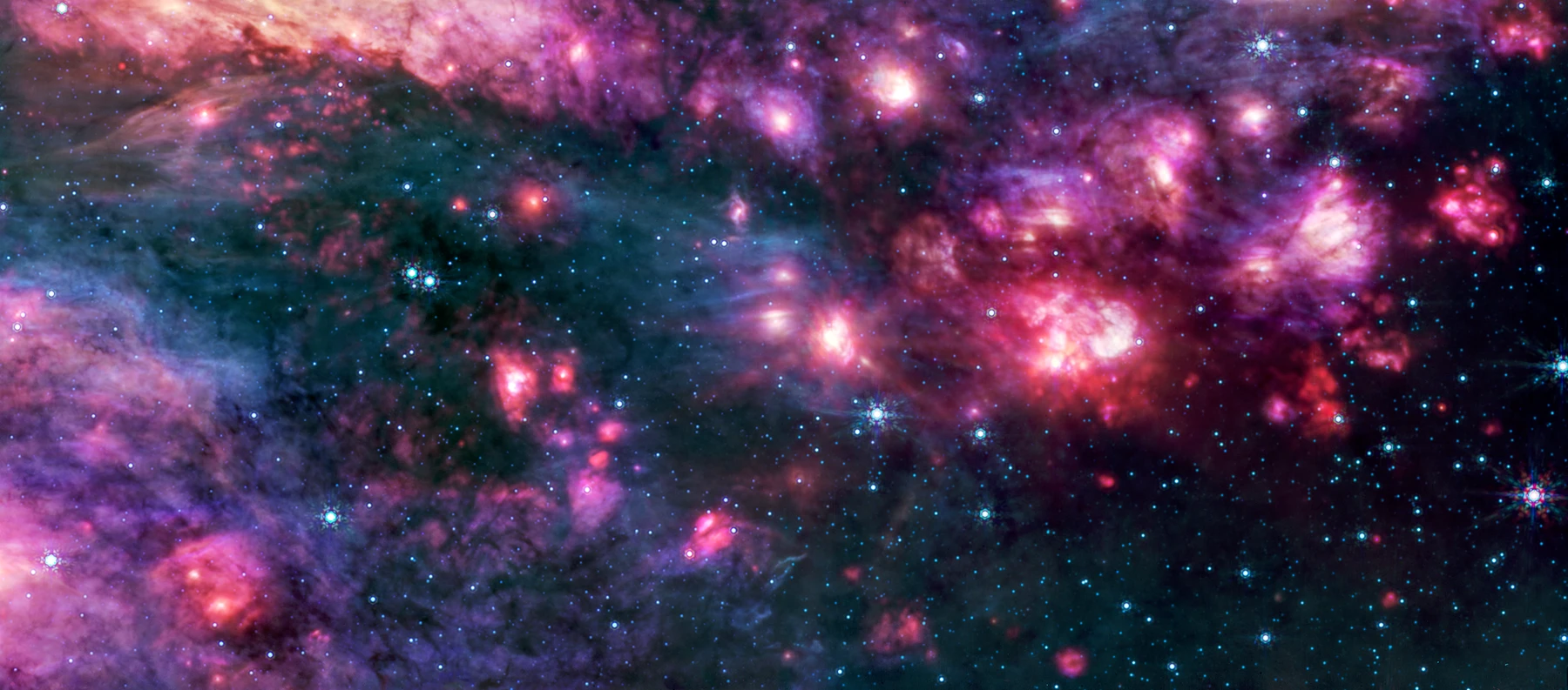 O imagine Webb/MIRI în infraroșu mediu a lui Sagittarius B2, cu nori moleculari roz și violet, benzi întunecate de praf și stele albastre strălucitoare. Este o imagine de context a unui mediu de nor molecular din Centrul Galactic, nu o imagine directă a lui G+0.693−0.027 sau a eritrulozei.